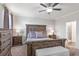 This spacious bedroom features a rustic wood bed frame, dresser and access to the bathroom at 112 Leveret Rd, Locust Grove, GA 30248