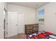 A bright bedroom offers a view of the green outdoors through a window at 112 Leveret Rd, Locust Grove, GA 30248