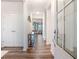 Stylish entryway with dark wood floors, white trim, and a view into the open-concept living area at 112 Leveret Rd, Locust Grove, GA 30248