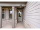 Inviting front porch with gray columns and brick base, providing a charming entrance to the home at 112 Leveret Rd, Locust Grove, GA 30248