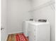 Practical laundry room featuring a washer, dryer, and convenient shelving at 112 Leveret Rd, Locust Grove, GA 30248
