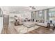 Open-concept living room showcasing a large sectional sofa and hardwood floors at 112 Leveret Rd, Locust Grove, GA 30248