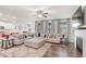 Spacious living room with a fireplace, plush sectional sofa, and an open view to the kitchen at 112 Leveret Rd, Locust Grove, GA 30248