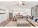 Open-concept living room showcasing a large sectional sofa and seamless transition to the kitchen at 112 Leveret Rd, Locust Grove, GA 30248
