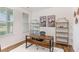 Bright home office featuring modern decor, a wooden desk, and large windows with a view at 112 Leveret Rd, Locust Grove, GA 30248