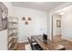 Cozy home office with a wooden desk, shelving, and a view of the stairs. Great workspace at 112 Leveret Rd, Locust Grove, GA 30248