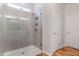 This modern shower features glass doors, gray tile and a shower head at 112 Leveret Rd, Locust Grove, GA 30248