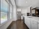 Kitchen featuring stainless steel appliances, white cabinetry, an island and large window with view at 1127 Provence Ln, Decatur, GA 30033