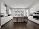 Bright kitchen with white cabinets, stainless steel appliances, and a large island with seating at 1127 Provence Ln, Decatur, GA 30033