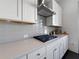 Close-up of kitchen detailing the gas cooktop, stylish tile backsplash, and pristine countertops at 1127 Provence Ln, Decatur, GA 30033