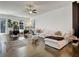 Bright living room with a ceiling fan, large windows and a comfortable white sofa at 1127 Provence Ln, Decatur, GA 30033