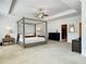 Large main bedroom with a four-poster bed, sitting area, and ensuite bathroom at 1127 Provence Ln, Decatur, GA 30033