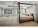 Bright main bedroom with a canopy bed, neutral carpet, and ample natural light at 1127 Provence Ln, Decatur, GA 30033