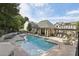 Community pool surrounded by lounge chairs and lush greenery at 1127 Provence Ln, Decatur, GA 30033