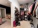 A full view of a large walk-in closet featuring shelving, hanging rods, and an entryway into the Primary bathroom at 1127 Provence Ln, Decatur, GA 30033