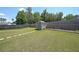 Expansive backyard with a lush green lawn, wooden fence and a shed at the rear at 2209 Cedar Place Ct, Snellville, GA 30078