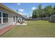 Spacious backyard featuring a patio set, a shed, and a well-maintained lawn at 2209 Cedar Place Ct, Snellville, GA 30078