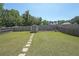 Expansive backyard with a lush green lawn, wooden fence and a shed at the rear at 2209 Cedar Place Ct, Snellville, GA 30078