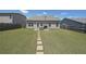 Large backyard with a green lawn, patio furniture, a wooden fence, and a pathway at 2209 Cedar Place Ct, Snellville, GA 30078