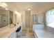 Bright bathroom featuring double sinks, soaking tub, glass shower, and tile flooring at 2209 Cedar Place Ct, Snellville, GA 30078