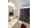 Bright bathroom featuring a vanity with a sink and a shower with a colorful patterned curtain at 2209 Cedar Place Ct, Snellville, GA 30078