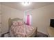 Cozy bedroom with a decorative bed frame and a window with pink and white curtains at 2209 Cedar Place Ct, Snellville, GA 30078