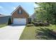 Charming home featuring a brick facade, manicured lawn, and a two-car garage at 2209 Cedar Place Ct, Snellville, GA 30078