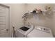 Laundry room with washer, dryer and shelving at 2209 Cedar Place Ct, Snellville, GA 30078