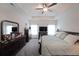 Well lit main bedroom with furnishing, TV, and neutral color carpet at 2209 Cedar Place Ct, Snellville, GA 30078