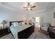 Main bedroom featuring a tray ceiling, fan, neutral walls, and furnishings at 2209 Cedar Place Ct, Snellville, GA 30078