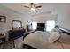 Main bedroom featuring a tray ceiling, ceiling fan, and furnishings at 2209 Cedar Place Ct, Snellville, GA 30078