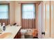 Well-lit bathroom with a vanity sink, toilet, and a window providing natural light at 2621 Manor Pl, Ellenwood, GA 30294