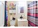 Functional bathroom featuring a vanity sink, toilet, and shower with patterned curtain at 2621 Manor Pl, Ellenwood, GA 30294