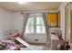 Cozy bedroom with natural light, playful decor, and cheerful color accents at 2621 Manor Pl, Ellenwood, GA 30294