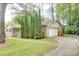 Brick home with an attached garage and driveway, featuring landscaped greenery and a well-maintained lawn at 2621 Manor Pl, Ellenwood, GA 30294