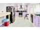 Modern kitchen with stainless steel appliances, colorful cabinetry, and an open design at 2621 Manor Pl, Ellenwood, GA 30294