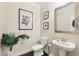 Powder bathroom with pedestal sink, framed art, dark floors, and neutral walls at 2793 Bloom Cir, Dacula, GA 30019