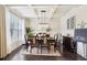 Elegant dining room with coffered ceiling, modern chandelier, and hardwood floors at 2793 Bloom Cir, Dacula, GA 30019