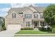 Charming two-story home with a brick facade, well-manicured lawn, attached garage, and inviting front porch at 2793 Bloom Cir, Dacula, GA 30019