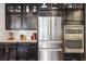 Gourmet kitchen featuring stainless steel appliances, granite countertops, and dark cabinets at 2793 Bloom Cir, Dacula, GA 30019