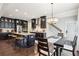 Modern kitchen featuring dark cabinetry, stainless steel appliances, granite countertops, and a breakfast bar at 2793 Bloom Cir, Dacula, GA 30019
