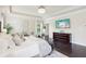 Spacious main bedroom featuring a tray ceiling, hardwood floors, and television at 2793 Bloom Cir, Dacula, GA 30019
