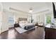 Spacious main bedroom featuring a tray ceiling, hardwood floors, and sitting area at 2793 Bloom Cir, Dacula, GA 30019