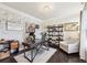 Elegant home office featuring a whitewashed brick accent wall, hardwood floors, and stylish furnishings at 2793 Bloom Cir, Dacula, GA 30019