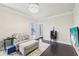 Sitting area with sofa, ottoman, and view to outdoor patio with lots of light at 2793 Bloom Cir, Dacula, GA 30019