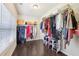 Spacious walk-in closet with hardwood floors, window, and storage racks at 2793 Bloom Cir, Dacula, GA 30019