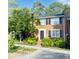 Charming two-story brick townhouse featuring a beautifully landscaped front yard and classic black shutters at 4620 Wieuca Ne Rd # 42, Atlanta, GA 30342
