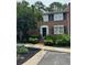 Charming brick townhome entrance with manicured landscaping and inviting walkway at 4620 Wieuca Ne Rd # 42, Atlanta, GA 30342