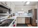 Updated kitchen boasts stainless appliances, bright white cabinets, and modern countertops, perfect for culinary enthusiasts at 4620 Wieuca Ne Rd # 42, Atlanta, GA 30342
