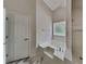 Bright bathroom boasts a large tub, a shower, and marble floors at 1229 Huntington Place Cir, Lithonia, GA 30058
